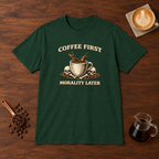 Coffee First Morality Later T-Shirt Forest Green flat lay on walnut coffee bar