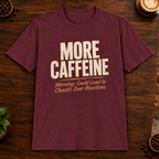 More Caffeine T-Shirt in Maroon on a dark wood coffee bar