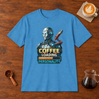 Coffee Loading Personality T-Shirt Heather Sapphire flat lay on walnut coffee bar
