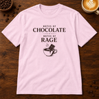 Notes of Rage T-Shirt in Light Pink on a dark wood coffee bar