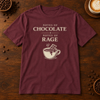 Notes of Rage T-Shirt in Maroon on a dark wood coffee bar