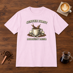 Coffee First Morality Later T-Shirt Light Pink flat lay on walnut coffee bar