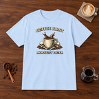 Coffee First Morality Later T-Shirt Light Blue flat lay on walnut coffee bar