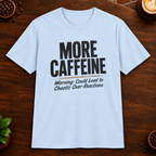 More Caffeine T-Shirt in Light Blue on a dark wood coffee bar