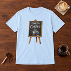 I Need Coffee T-Shirt Light Blue flat lay on walnut coffee bar