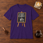I Need Coffee T-Shirt Purple flat lay on walnut coffee bar
