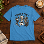 I Come in Peace T-Shirt Heather Sapphire on warm coffee bar