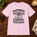 Caffeine is Required T-Shirt Light Pink on warm coffee bar