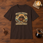 Bean There Drank That T-Shirt Dark Chocolate flat lay on walnut coffee bar