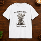 Bloom First T-Shirt in White on a wooden coffee-themed background