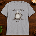 Decaf is Just Performance Art T-Shirt in Sport Grey, close-up on dark wood coffee bar
